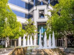Class A office building with landscaped fountain entrance at 21300 Victory Blvd
