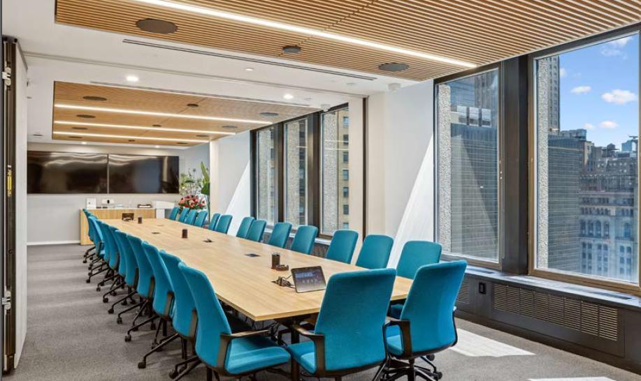 Conference room with long table, blue chairs, wood ceiling and city views