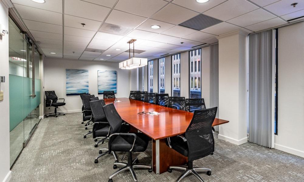 large windowed room with table and 14 seats