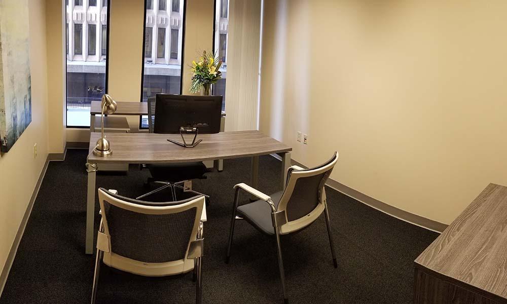 Office for attorney with windows and desk and chairs