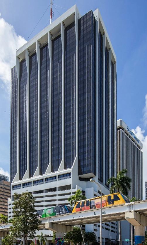 Tall glass office tower with distinctive architecture overlooking Biscayne Bay